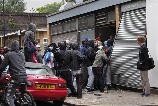 Smashed   hooded looters storm shop Hackney