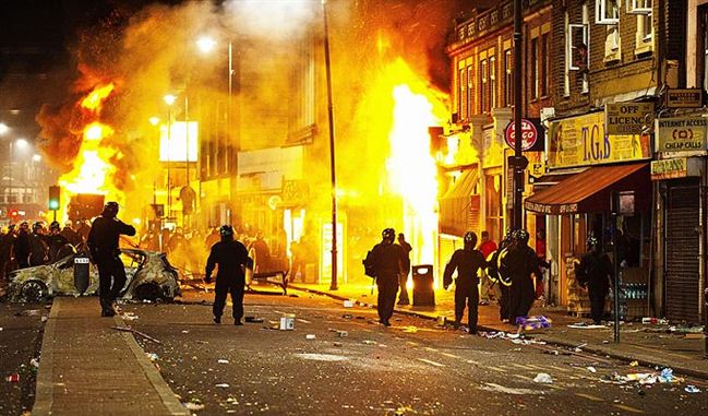 Stand off  riot cops move Tottenham burns